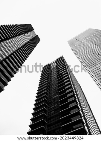 alone in the crowd. just alone. black and white. Details of buildings.