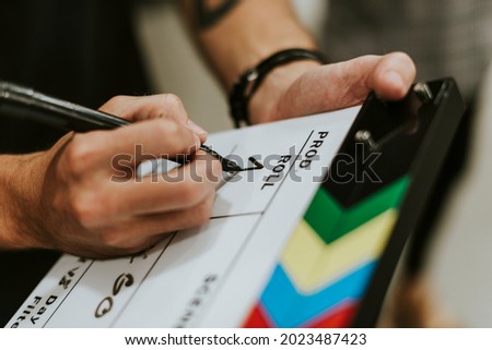 Behind the scenes with a clapper board Royalty-Free Stock Photo #2023487423