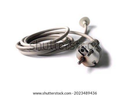 Danger caused by electric shock at the plug terminals Old, damaged power cable of the computer. Thus causing black burns that may cause damage and short-circuit. Isolated. Royalty-Free Stock Photo #2023489436