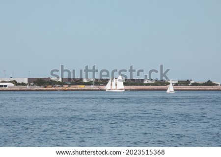 Sailboat on Boston airport background seen from Piers Park, Massachusetts, USA