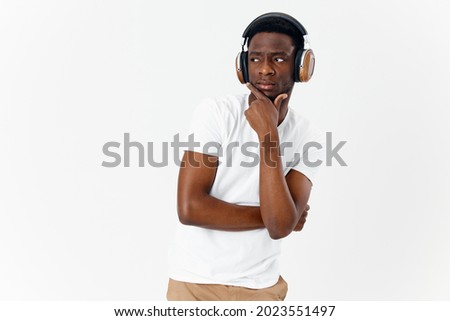 a man of african appearance with headphones listening to music