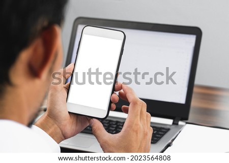 Closeup businessman using smartphone working in office