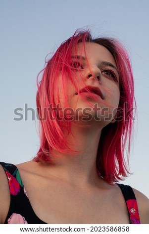 Portrait of a positive pink-haired teenage girl.Street style.Summer concept.Generation Z style.