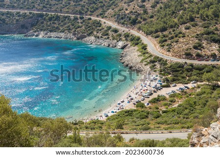 people swimming in a turquoise bay and camping
