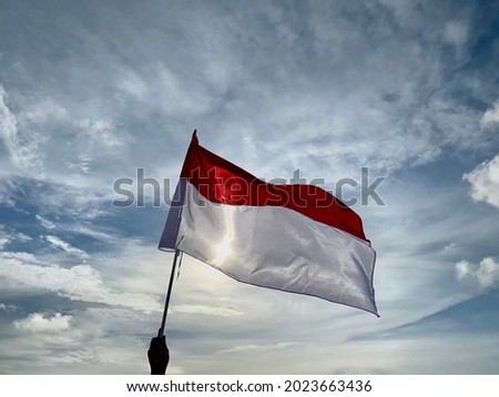 Indonesian flag flying in the blue sky