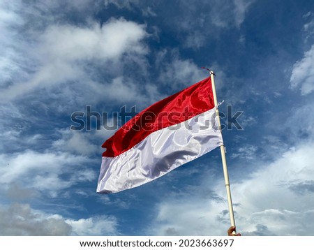 Indonesian flag flying in the blue sky