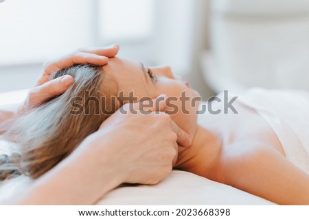 real doctor osteopath hands does physiological and emotional therapy for eight year old kid girl. pediatric osteopathy treatment session. alternative medicine. taking care of the child's health Royalty-Free Stock Photo #2023668398
