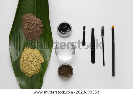 Composition with henna for eyebrows correction on light background