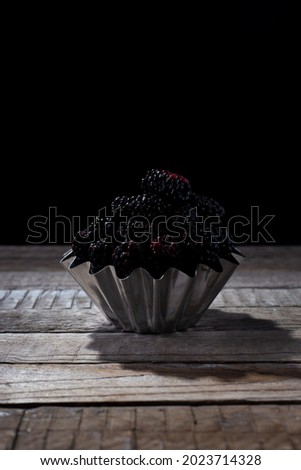 black berry on a black background in a rustic style.