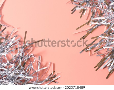 silver tinsel frame, horizontal image with free space for text, silver tinsel on pink background, template banner for New Year's party