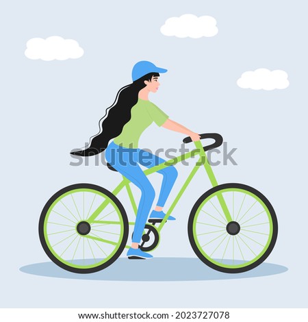 Girl dressed in sport clothes riding bicycle. Healthy and sporty lifestyle concept.
