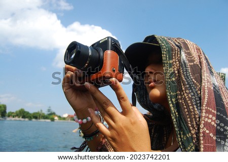 Travelers thai women people travel visit shooting take photo on boat tour trip Tam Coc Bich Dong or Halong Bay on Land and Ngo Dong river and cave of limestone mountains at Ninh Binh in Hanoi, Vietnam