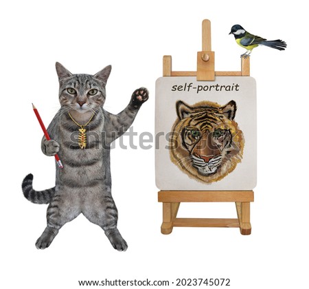 A gray cat artist with a pencil paints his self-portrait on a canvas on an easel. White background. Isolated.