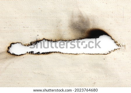 Burn hole on canvas fabric texture and background. Royalty-Free Stock Photo #2023764680