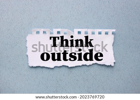 Think Outside. white torn paper with text on blue background
