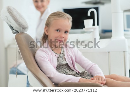 A little girl visiting dentist and feeling excited