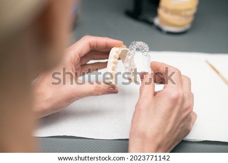 Close up picture of hands with dental prosthesis