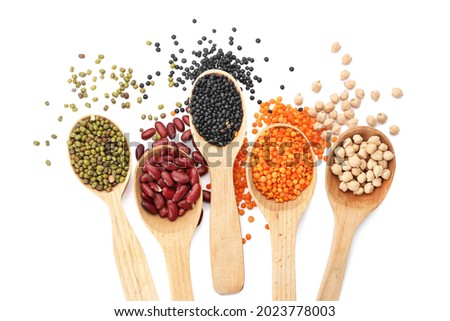 Spoons with different legumes on white background Royalty-Free Stock Photo #2023778003