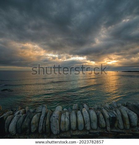 Golden hues in a cloudy sunrise over the Cantabrian from Ribadeo in Galicia