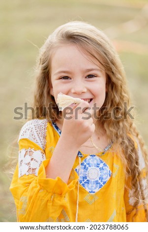 Ukraine's Independence Flag Day. Girl in traditional embroidery with flag of Ukraine in field. Constitution day. 24 August. Patriotic holiday.