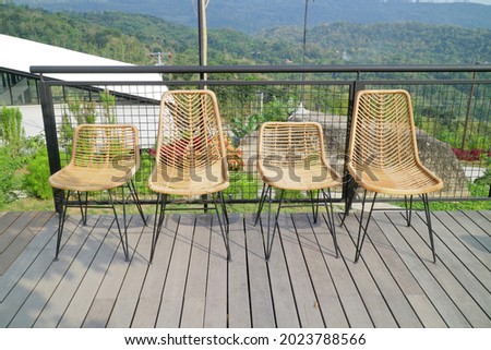 four wooden chairs on the balcony of the house photo