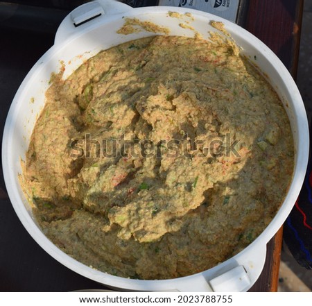 A picture of a freshly prepared batter, to use to prepare the meal like pakoda, curry.