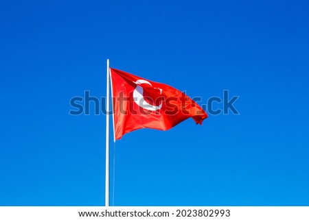 Flag of the Republic of Turkey. Turkish national flag waving. Isolated on clear blue sky background.May 19 (19 Mayıs), October 29 (29 Ekim), August 30 (30 Ağustos), April 23 (23 Nisan) background.
