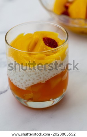 Sweet tapioca pudding with fresh mango and strawberry