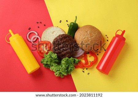 Concept of cooking burger on two tone background