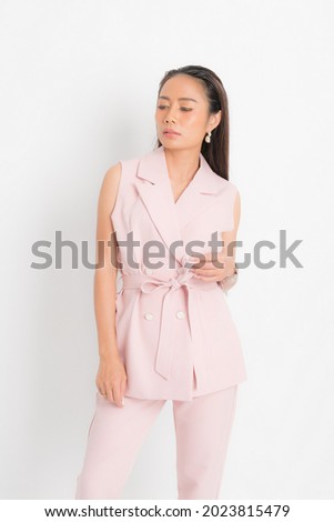 Fashion style catalog clothing for business woman black long hair natural make up wear pink suit costume perfect body shape suit at studio shoot on white background and shadow.
