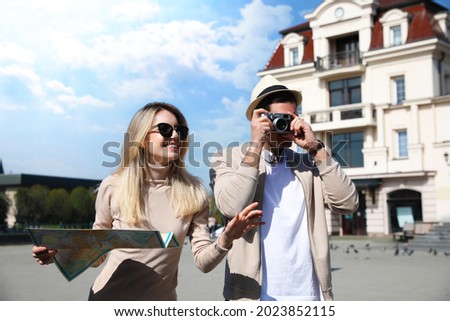 Couple of tourists taking picture on beautiful city street