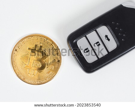 Closeup golden bitcoin with car remote white background