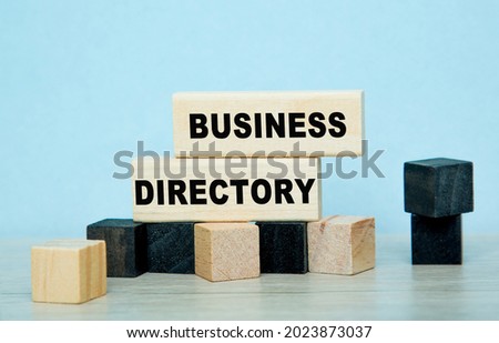 DIRECTORY BUSINESS words on wooden cubes on white desk.
