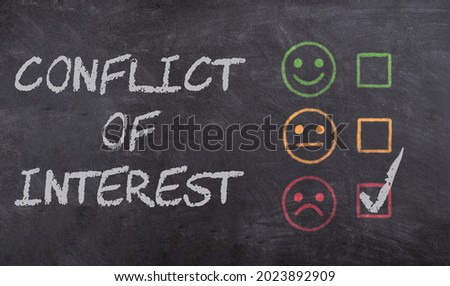 Conflict of Interest text written on blackboard with chalk. Concept for mediation, resolving conflict, dispute. Royalty-Free Stock Photo #2023892909