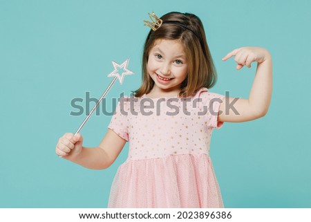 Little fun kid girl princess 5-6 years old wears pink dress crown diadem hold magic wand fairy stick isolated on pastel blue color background child studio. Mother's Day love family lifestyle concept