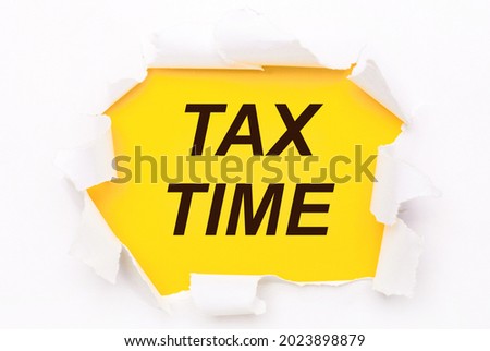 Torn white paper lies on a bright yellow background with the text TAX TIME