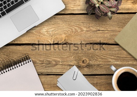 Laptop keyboard, a cup of coffee on the wooden office desk