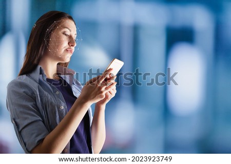 Young woman using face recognition via smart mobile phone indoors, Biometric Verification Royalty-Free Stock Photo #2023923749