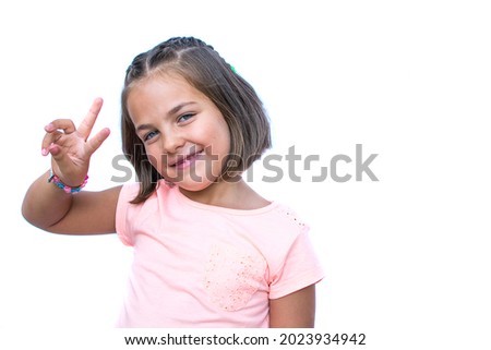 Portrait Of Girl On White Background. Little Girl Of 6 Years Caucasian Has Blue Eyes. Image With Copy Space. Child With Positive And Joyful Expression