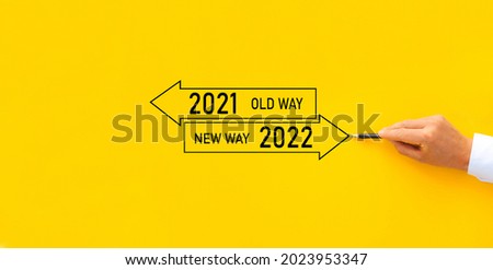 Improvement and change management. Businessman draw arrow panel with Old Way 2021 and New way of the  year 2022. Royalty-Free Stock Photo #2023953347
