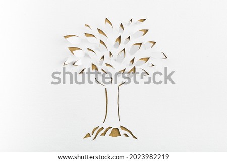 Origami tree with a leaf on white paper