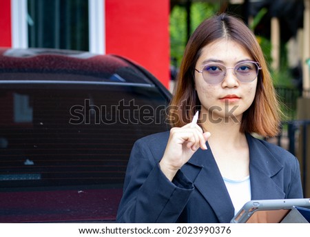 Asian business woman Checking the work on a laptop