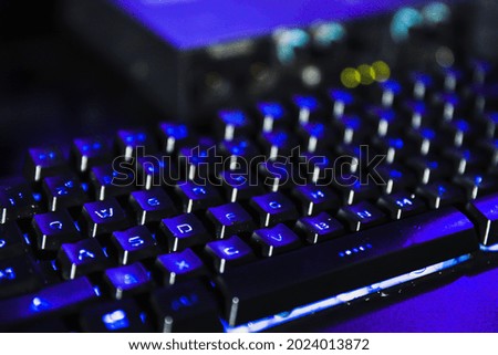PC Keyboard with glowing blue light background