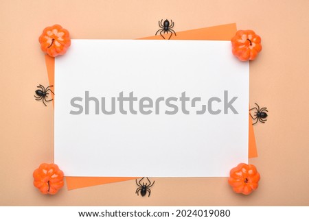 Background for the Halloween holiday with pumpkins and spiders there is a place for text on a white blank sheet of paper. Flat layout, top view, a place to copy.