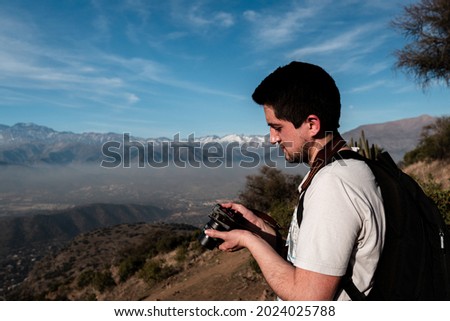 Portrait of young man checking camera on sunny day
