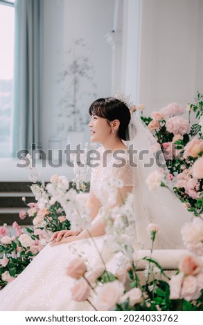 A beautiful bride on her wedding day. Korean Asian female model.  The bride wore a gorgeous wedding dress decorated with beads. Emotional photo. high resolution photo.