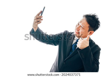 Middle-aged men in suits taking selfies