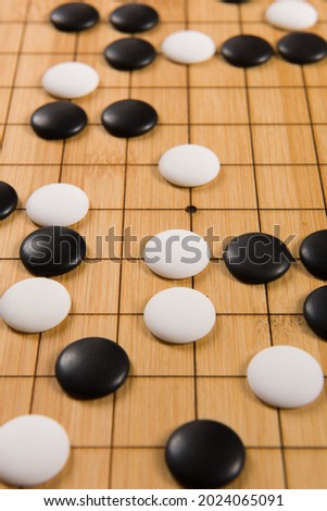 Desk for board game Go or Weiqi  and black and white bones. Traditional asian strategy boardgame