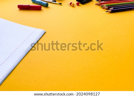 School supplies on yellow background top view. Creative frame layout with school stationery. Flat lay. Colored stationery. Isolated background.  Copy space.  Back to school