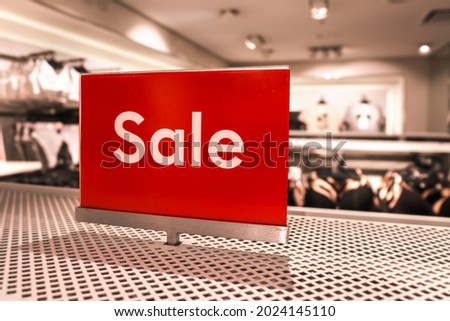 Word sale on red background on advertising commercial signage at clothes store